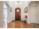 Elegant foyer with hardwood floors, arched doorways, and a decorative chandelier at 9399 Irishmans Run Ln, Zionsville, IN 46077