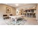 Game room featuring a pool table, bar with seating, and neutral walls at 9399 Irishmans Run Ln, Zionsville, IN 46077