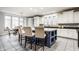 Bright kitchen featuring a blue island with seating, white cabinetry, and modern appliances at 9399 Irishmans Run Ln, Zionsville, IN 46077