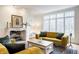 Sunlit living room featuring a fireplace, comfortable sofas, and a large window at 9399 Irishmans Run Ln, Zionsville, IN 46077