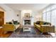 Elegant living room showcasing a fireplace, plush sofas, and large windows at 9399 Irishmans Run Ln, Zionsville, IN 46077