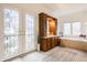 Main bathroom with double doors, a vanity, large mirror, and separate tub at 9399 Irishmans Run Ln, Zionsville, IN 46077