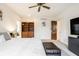 Spacious main bedroom with a ceiling fan, built-in shelves, and an ensuite bath at 9399 Irishmans Run Ln, Zionsville, IN 46077
