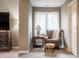 Comfortable sitting area with an armchair, footstool, and a lamp at 9399 Irishmans Run Ln, Zionsville, IN 46077