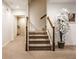 Inviting stairway with neutral carpet, decorative tree and ample lighting at 9399 Irishmans Run Ln, Zionsville, IN 46077