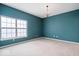 Bright bedroom with teal walls and neutral carpet at 1088 Laurelwood Ln, Greenwood, IN 46142
