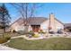 Charming stone house with landscaped yard and double front doors at 1088 Laurelwood Ln, Greenwood, IN 46142