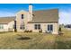 View of the home's backyard, showcasing a well-kept lawn, patio space, and a view of the neighborhood at 10917 Hunter Lake Ln, Indianapolis, IN 46239