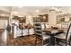 A dining area features wood floors, a dark wood table and dark wood cabinets in the attached kitchen at 10917 Hunter Lake Ln, Indianapolis, IN 46239