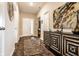 Inviting home foyer with stylish decor, featuring a console table, artwork, and a decorative rug on hardwood floors at 10917 Hunter Lake Ln, Indianapolis, IN 46239