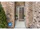 Elegant front entryway featuring a stylish door, brick accents, and manicured greenery, creating a welcoming appeal at 10917 Hunter Lake Ln, Indianapolis, IN 46239