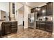 A kitchen features stainless steel appliances, dark wood cabinets, and views of the staircase at 10917 Hunter Lake Ln, Indianapolis, IN 46239