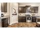 A kitchen features stainless steel appliances, granite countertops, and dark wood cabinets at 10917 Hunter Lake Ln, Indianapolis, IN 46239