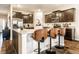 A kitchen island has granite counters and bar seating; stainless steel appliances and dark wood cabinets at 10917 Hunter Lake Ln, Indianapolis, IN 46239