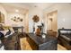 Cozy living room showcasing a plush leather sofa, decorative wall art, and a view into an adjacent room at 10917 Hunter Lake Ln, Indianapolis, IN 46239