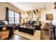 Inviting living room featuring a comfortable black leather sofa, stylish decor, and a large window with natural light at 10917 Hunter Lake Ln, Indianapolis, IN 46239