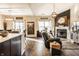 Open layout living room with a kitchen island, dining area, fireplace, and comfortable leather seating at 10917 Hunter Lake Ln, Indianapolis, IN 46239