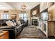 Well-lit living area with a cozy fireplace, large TV, comfortable seating, and stylish decor at 10917 Hunter Lake Ln, Indianapolis, IN 46239