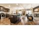 Open concept living room featuring kitchen island, fireplace, hardwood floors, and comfortable seating at 10917 Hunter Lake Ln, Indianapolis, IN 46239