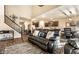Spacious open-concept living area with stairs, adjacent to the kitchen, and complete with modern furnishings at 10917 Hunter Lake Ln, Indianapolis, IN 46239