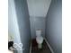Small, updated half bathroom with gray walls and wood-look floor at 1459 W 33Rd St, Indianapolis, IN 46208