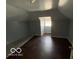 Bright bedroom featuring a window and wood-look floors at 1459 W 33Rd St, Indianapolis, IN 46208