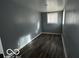 Simple bedroom with gray walls, wood-look floors, and a window at 1459 W 33Rd St, Indianapolis, IN 46208