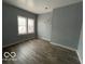 Spacious bedroom with wood-look flooring and large window at 1459 W 33Rd St, Indianapolis, IN 46208