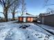 Brick home with snowy backyard and detached garage at 1459 W 33Rd St, Indianapolis, IN 46208