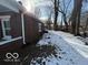 Brick home with snowy backyard and mature trees at 1459 W 33Rd St, Indianapolis, IN 46208