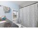Bathroom with granite vanity, shower/tub combo, and window at 1743 Sparrow Ave, Indianapolis, IN 46227