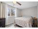 Primary bedroom with double window, ceiling fan, and gray bedding at 1743 Sparrow Ave, Indianapolis, IN 46227