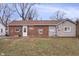 Brick and siding house exterior with a yard at 1743 Sparrow Ave, Indianapolis, IN 46227
