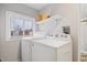Laundry room with washer, dryer, and overhead shelving at 1743 Sparrow Ave, Indianapolis, IN 46227