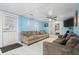 Bright living room with light blue walls and comfy sofas at 1743 Sparrow Ave, Indianapolis, IN 46227