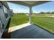 Back patio overlooking a large grassy lawn, perfect for outdoor activities and entertaining in a serene setting at 19438 Astoria Ave, Sheridan, IN 46069