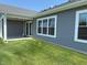 Home featuring a well-manicured lawn, covered back patio, and vinyl siding, ideal for outdoor relaxation and entertaining at 19438 Astoria Ave, Sheridan, IN 46069