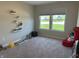 Bedroom with large windows, neutral walls and carpet flooring, and colorful decorations at 19438 Astoria Ave, Sheridan, IN 46069