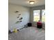 Cozy bedroom with carpet, shelving, and natural light from the windows overlooking the front yard at 19438 Astoria Ave, Sheridan, IN 46069