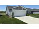 Charming home with a spacious two-car garage and concrete driveway, surrounded by well-manicured lawn and landscaping at 19438 Astoria Ave, Sheridan, IN 46069