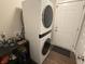Laundry area with a stacked washer and dryer set and access to the home's exterior at 19438 Astoria Ave, Sheridan, IN 46069
