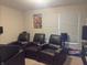 Home theater with leather recliners, a window with blinds, and surround sound speakers for entertainment at 19438 Astoria Ave, Sheridan, IN 46069