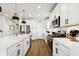 Modern white kitchen with stainless steel appliances and hardwood floors at 19723 Atwater Ave, Sheridan, IN 46069