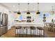 Open kitchen with island, breakfast bar, and stylish light fixtures at 19723 Atwater Ave, Sheridan, IN 46069
