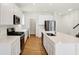 Modern kitchen with white cabinets, island, and stainless steel appliances at 19723 Atwater Ave, Sheridan, IN 46069