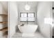 Free-standing soaking tub and floating shelves in modern bathroom at 2301 Nowland Ave, Indianapolis, IN 46201