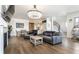 Spacious living area featuring hardwood floors, a large TV, and a modern chandelier at 2301 Nowland Ave, Indianapolis, IN 46201
