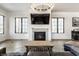 Elegant living room with hardwood floors, a gas fireplace and a large TV at 2301 Nowland Ave, Indianapolis, IN 46201