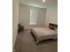 Main bedroom with window, carpet, and a folding chair at 2746 Lanai Ln, Greenwood, IN 46143