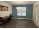 Dining area with dark wood table and chairs, and blue accent wall at 2746 Lanai Ln, Greenwood, IN 46143